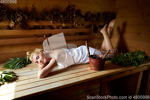 Image of beautiful girl relaxing in sauna