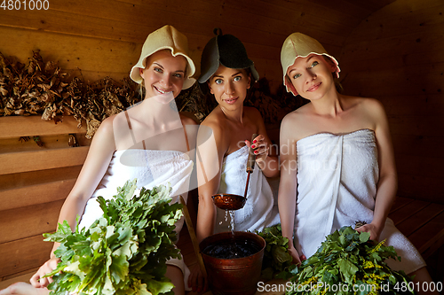 Image of three girls relaxing in sauna