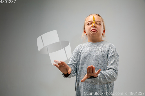 Image of Caucasian girl wearing the respiratory protection mask against air pollution and dusk on grey studio background