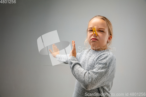 Image of Caucasian girl wearing the respiratory protection pin clasp against air pollution and dusk on grey studio background