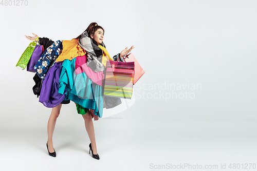 Image of Woman addicted of sales and clothes, overproduction and crazy demand