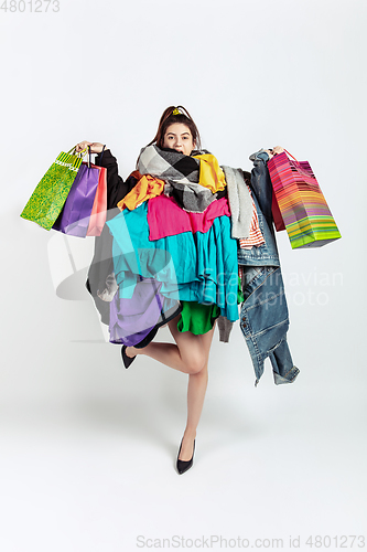 Image of Woman addicted of sales and clothes, overproduction and crazy demand