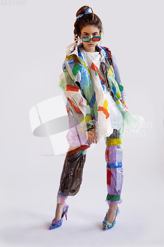 Image of Woman addicted of sales and clothes, wearing plastic, recycling concept