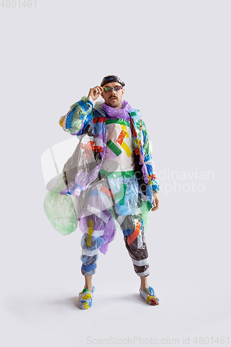 Image of Man addicted of sales and clothes, wearing plastic, recycling concept