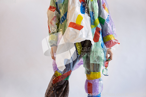 Image of Woman addicted of sales and clothes, wearing plastic, recycling concept