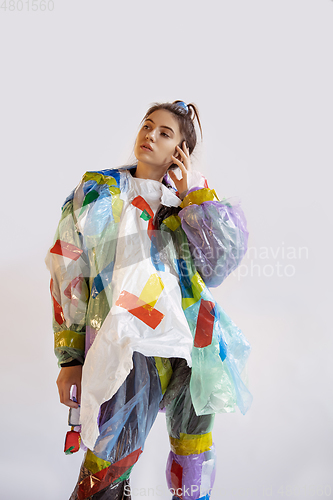 Image of Woman addicted of sales and clothes, wearing plastic, recycling 