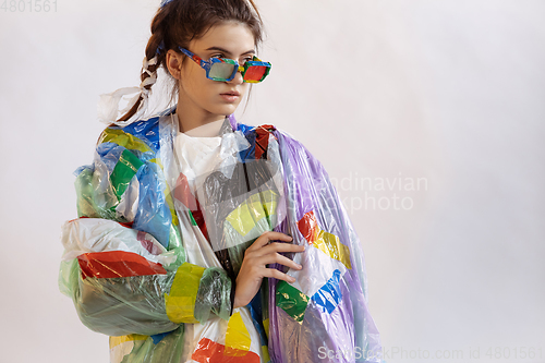 Image of Woman addicted of sales and clothes, wearing plastic, recycling concept