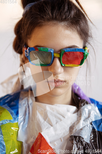 Image of Woman addicted of sales and clothes, wearing plastic, recycling concept