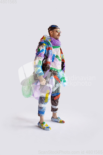 Image of Man addicted of sales and clothes, wearing plastic, recycling concept
