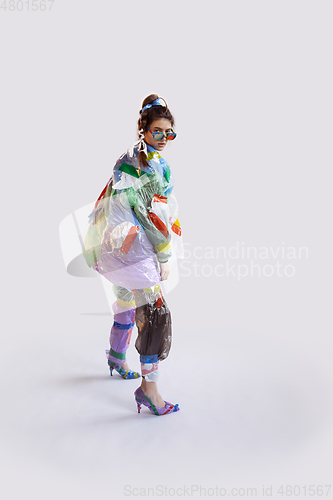 Image of Woman addicted of sales and clothes, wearing plastic, recycling concept