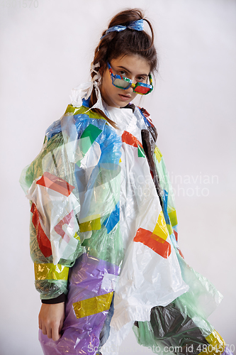 Image of Woman addicted of sales and clothes, wearing plastic, recycling concept