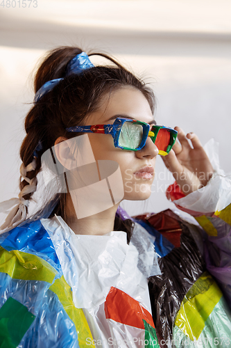 Image of Woman addicted of sales and clothes, wearing plastic, recycling concept