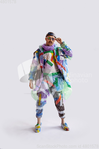 Image of Man addicted of sales and clothes, wearing plastic, recycling concept