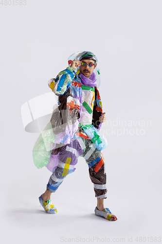 Image of Man addicted of sales and clothes, wearing plastic, recycling concept