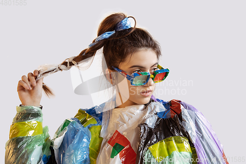 Image of Woman addicted of sales and clothes, wearing plastic, recycling concept