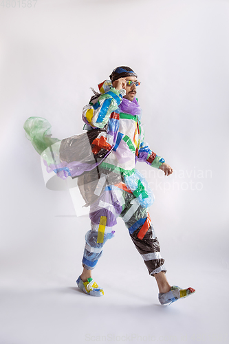 Image of Man addicted of sales and clothes, wearing plastic, recycling concept