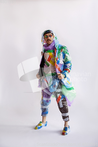 Image of Man addicted of sales and clothes, wearing plastic, recycling concept