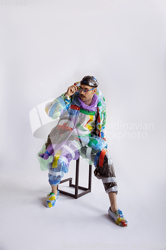 Image of Man addicted of sales and clothes, wearing plastic, recycling concept