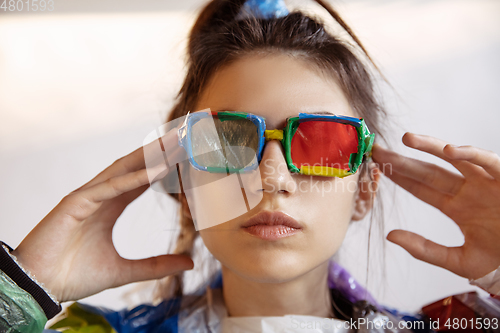 Image of Woman addicted of sales and clothes, wearing plastic, recycling concept