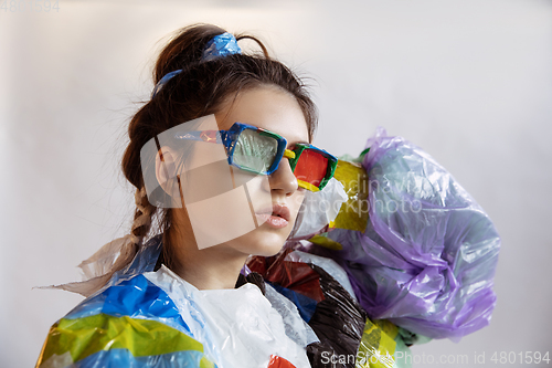 Image of Woman addicted of sales and clothes, wearing plastic, recycling concept