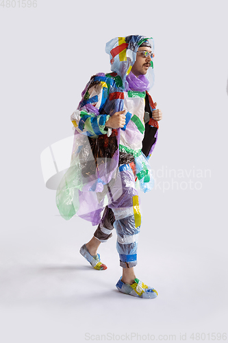 Image of Man addicted of sales and clothes, wearing plastic, recycling concept