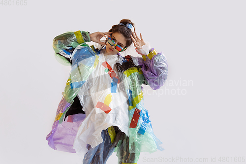 Image of Woman addicted of sales and clothes, wearing plastic, recycling concept