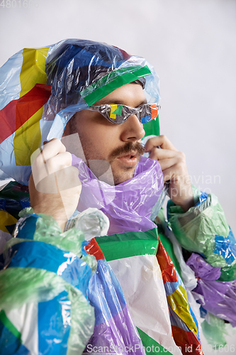 Image of Man addicted of sales and clothes, wearing plastic, recycling concept