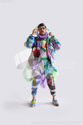 Image of Man addicted of sales and clothes, wearing plastic, recycling concept