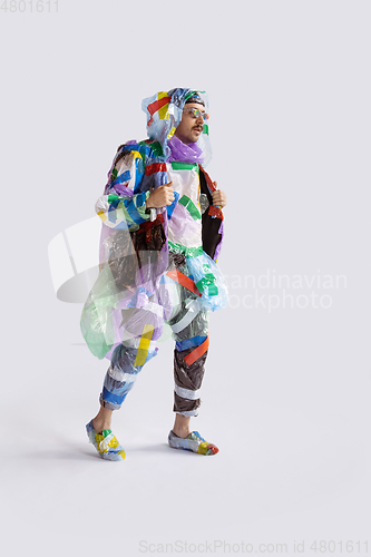 Image of Man addicted of sales and clothes, wearing plastic, recycling concept