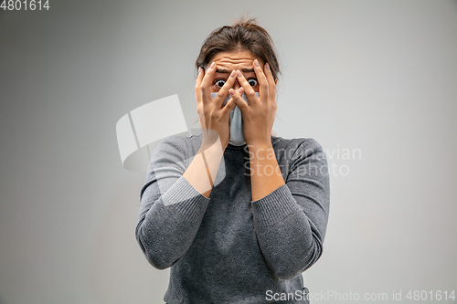 Image of Caucasian woman wearing the respiratory protection mask against air pollution and dusk on grey studio background