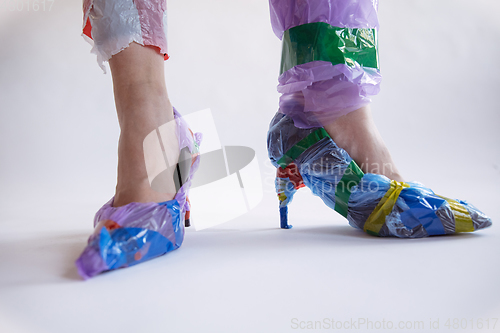 Image of Woman addicted of sales and clothes, wearing plastic, recycling concept