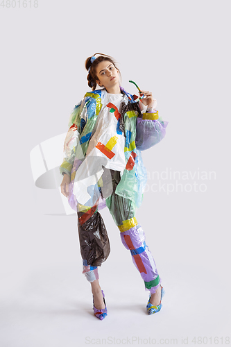 Image of Woman addicted of sales and clothes, wearing plastic, recycling 