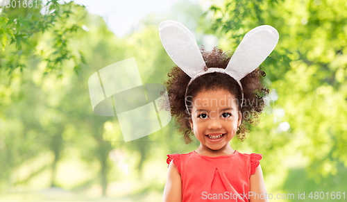 Image of happy little girl wearing easter bunny ears