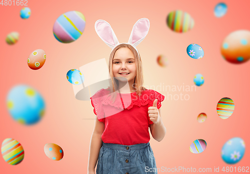 Image of girl wearing easter bunny ears showing thumbs up