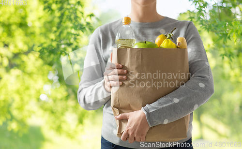 Image of close up of woman with paper bag full of food