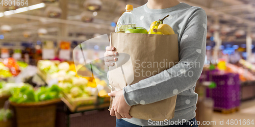 Image of close up of woman with paper bag full of food