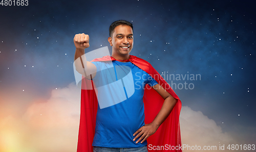 Image of indian man in superhero cape makes winning gesture