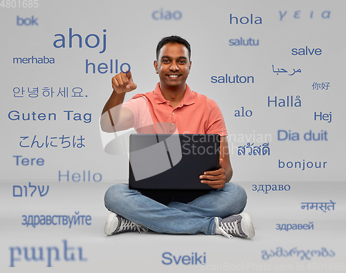 Image of happy indian man with laptop learning languages