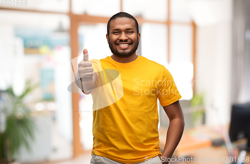 Image of smiling african american man showing thumbs up