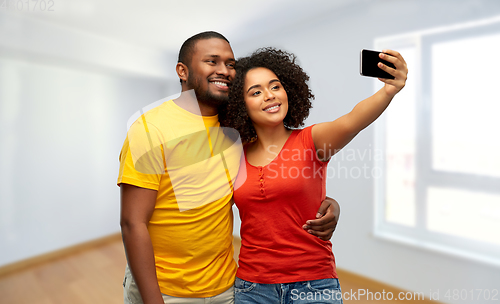 Image of african american couple takes selfie by smartphone