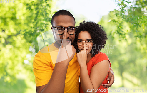 Image of happy african american couple in glasses hugging