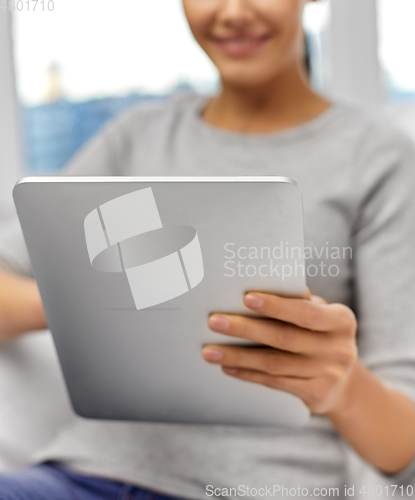 Image of close up of woman with tablet pc computer at home