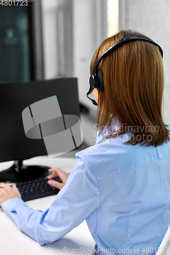 Image of businesswoman with headset and computer at office