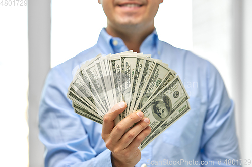 Image of smiling businessman with american dollar money