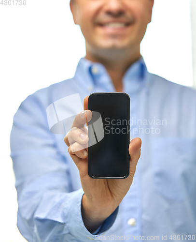 Image of happy businessman showing smartphone screen