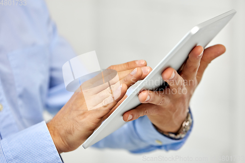 Image of close up of male hands with tablet pc computer