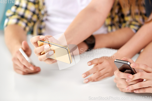 Image of close up of hands with smartphones