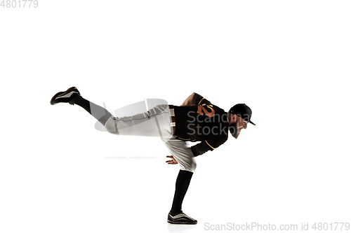 Image of Baseball player, pitcher in a black uniform practicing on a white background.