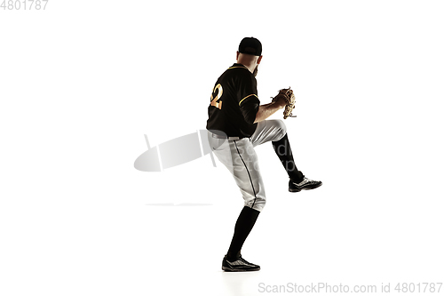 Image of Baseball player, pitcher in a black uniform practicing on a white background.