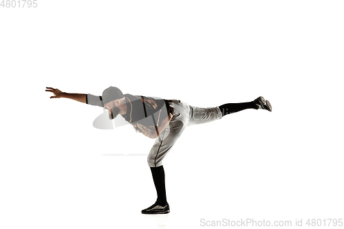 Image of Baseball player, pitcher in a black uniform practicing on a white background.